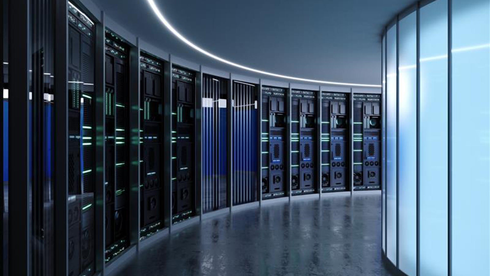 A modern, curved data center corridor with rows of mission critical server racks illuminated by blue and green LED lights. The floor is reflective, and frosted glass walls line one side of the sleek, high-tech space.