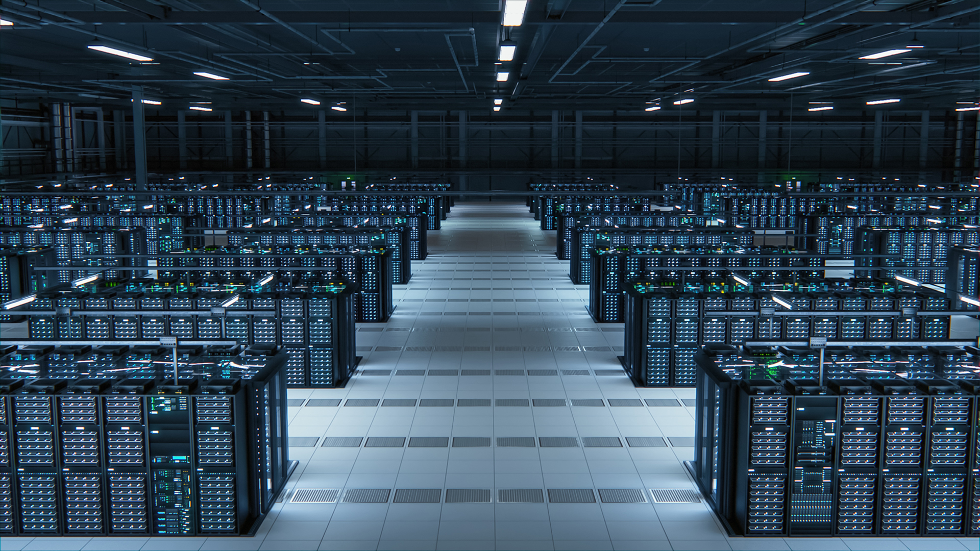 A large, brightly lit data center filled with rows of mission critical server racks and computer equipment, all neatly arranged across a tiled floor.