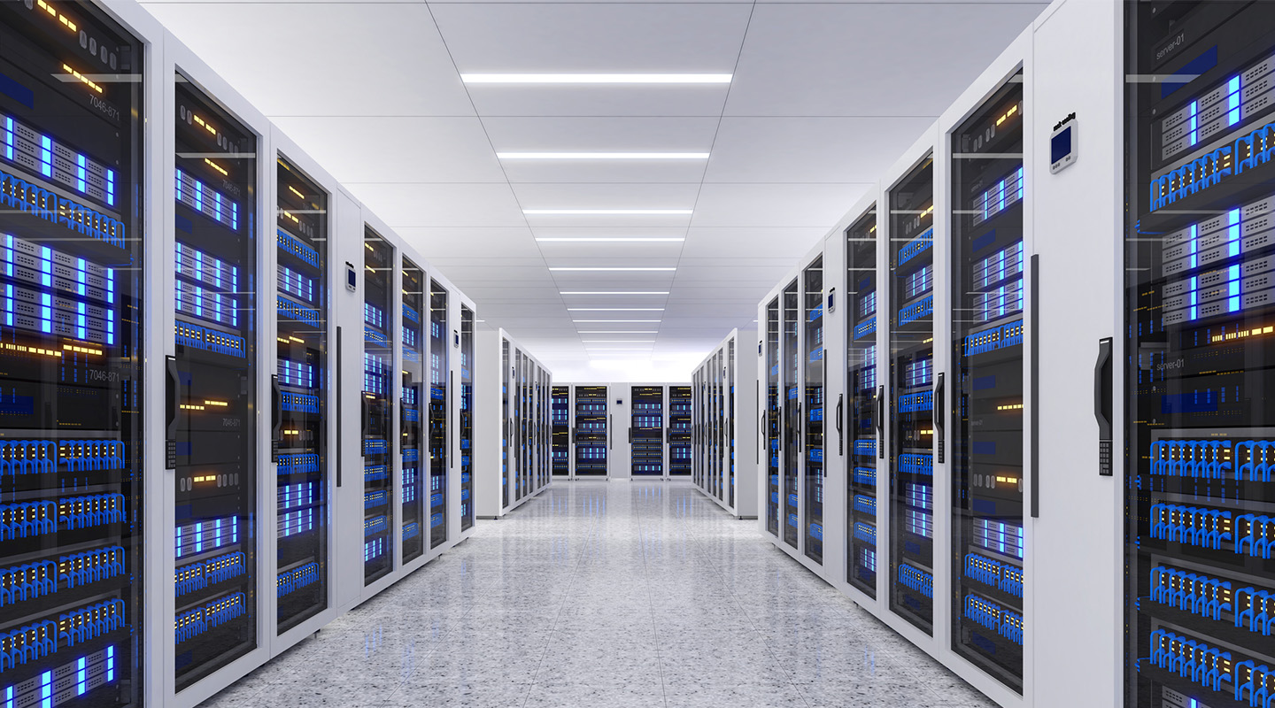 A modern data center corridor lined with rows of server racks on both sides, featuring blue and yellow LED lights on the equipment and a clean, reflective floor under bright ceiling lights.