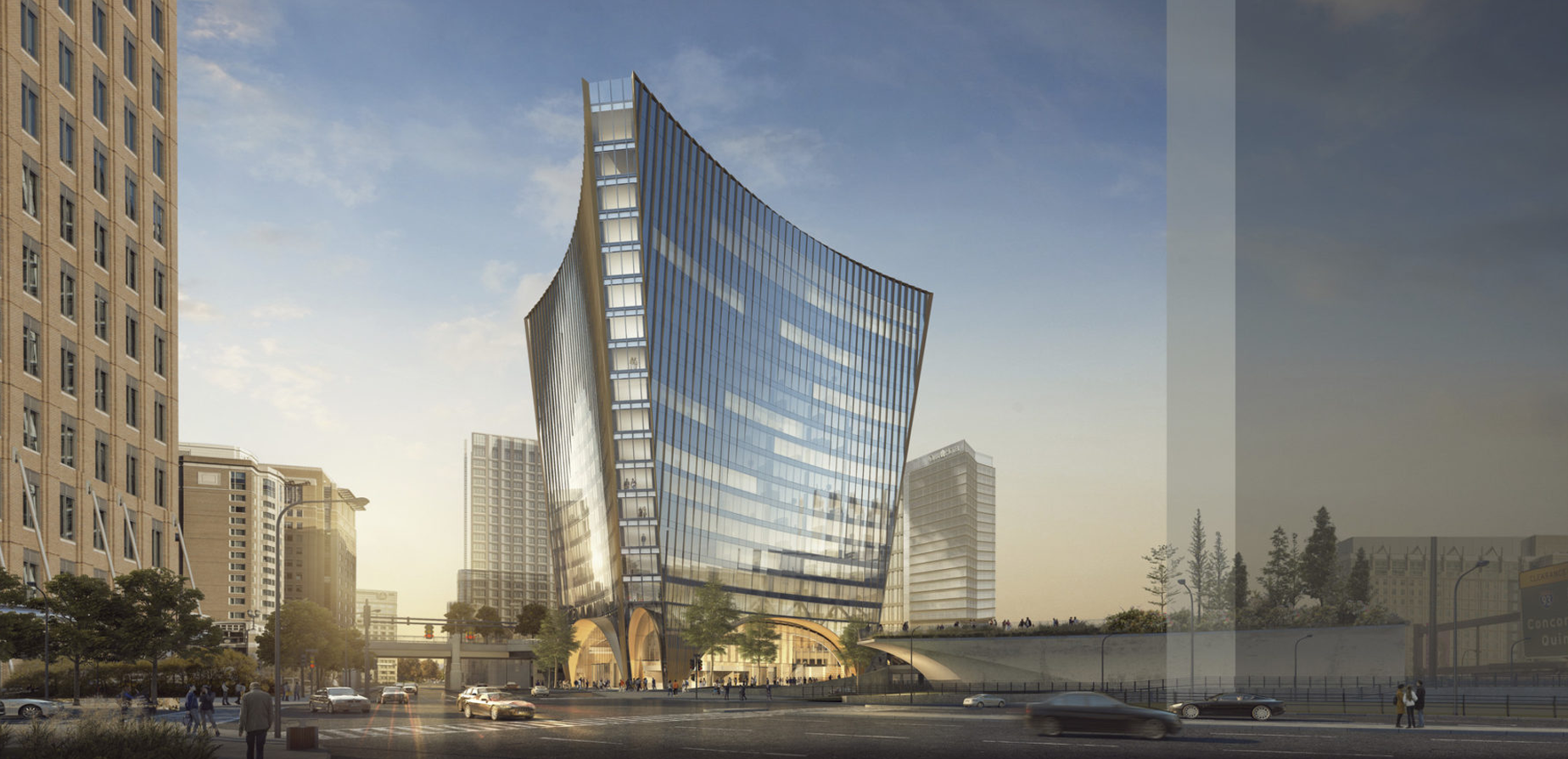 A modern, glass skyscraper with a curved facade stands at a city intersection, surrounded by other tall buildings, trees, and cars on the street under a clear sky at sunset.