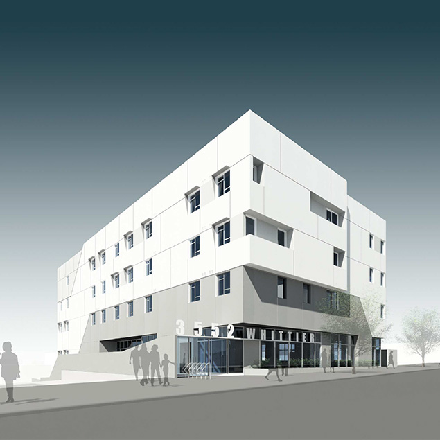 A modern, angular building with a white and gray facade, large windows, and geometric shapes. Several people are walking near the entrance, and the sky is clear with a gradient from light to dark blue.