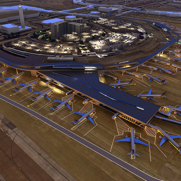 Aerial view of a large airport terminal at night, with multiple airplanes parked at gates and a well-lit parking area and buildings in the background.