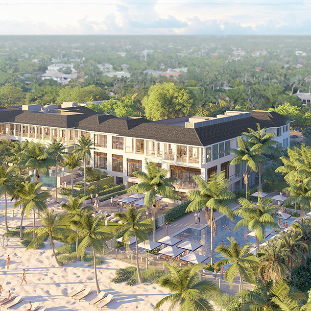 Aerial view of a beachfront resort surrounded by palm trees, with a pool and lounge chairs near the sandy beach. The modern building has large windows and overlooks a lush, green landscape in the background.