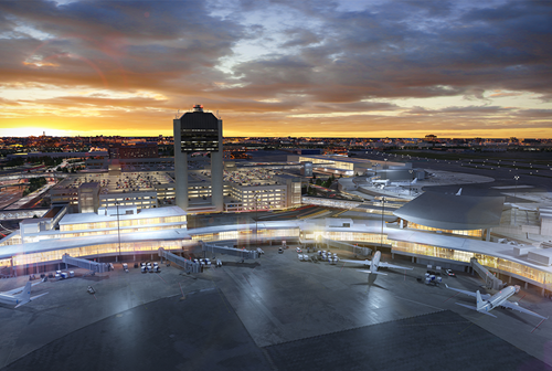 Aerial view of an airport at sunset, with terminals, airplanes parked at gates, and a tall control tower in the center, illuminated by lights under a colorful sky.
