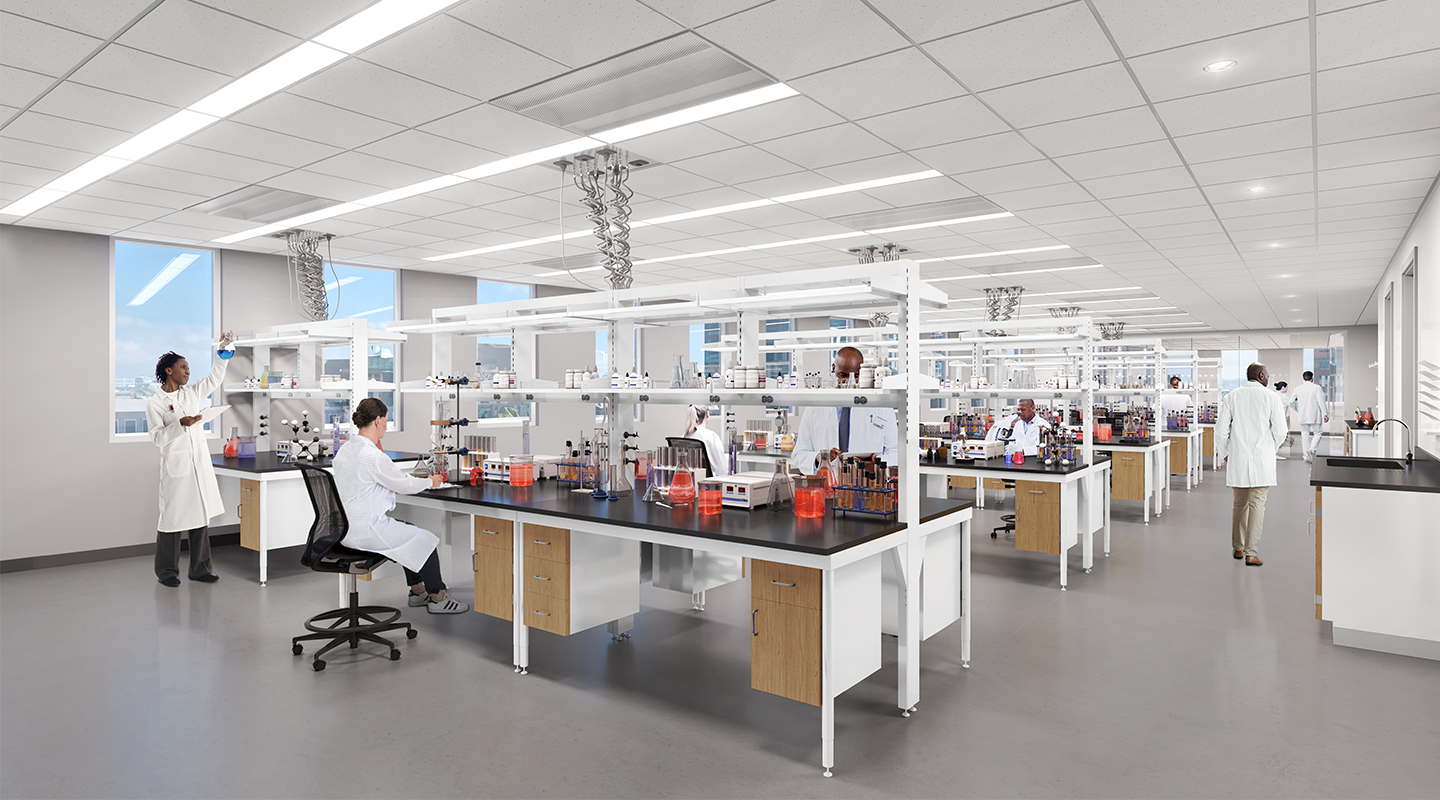 Large, modern laboratory with multiple scientists in white lab coats working at benches with scientific equipment, glassware, and computers under bright overhead lights.