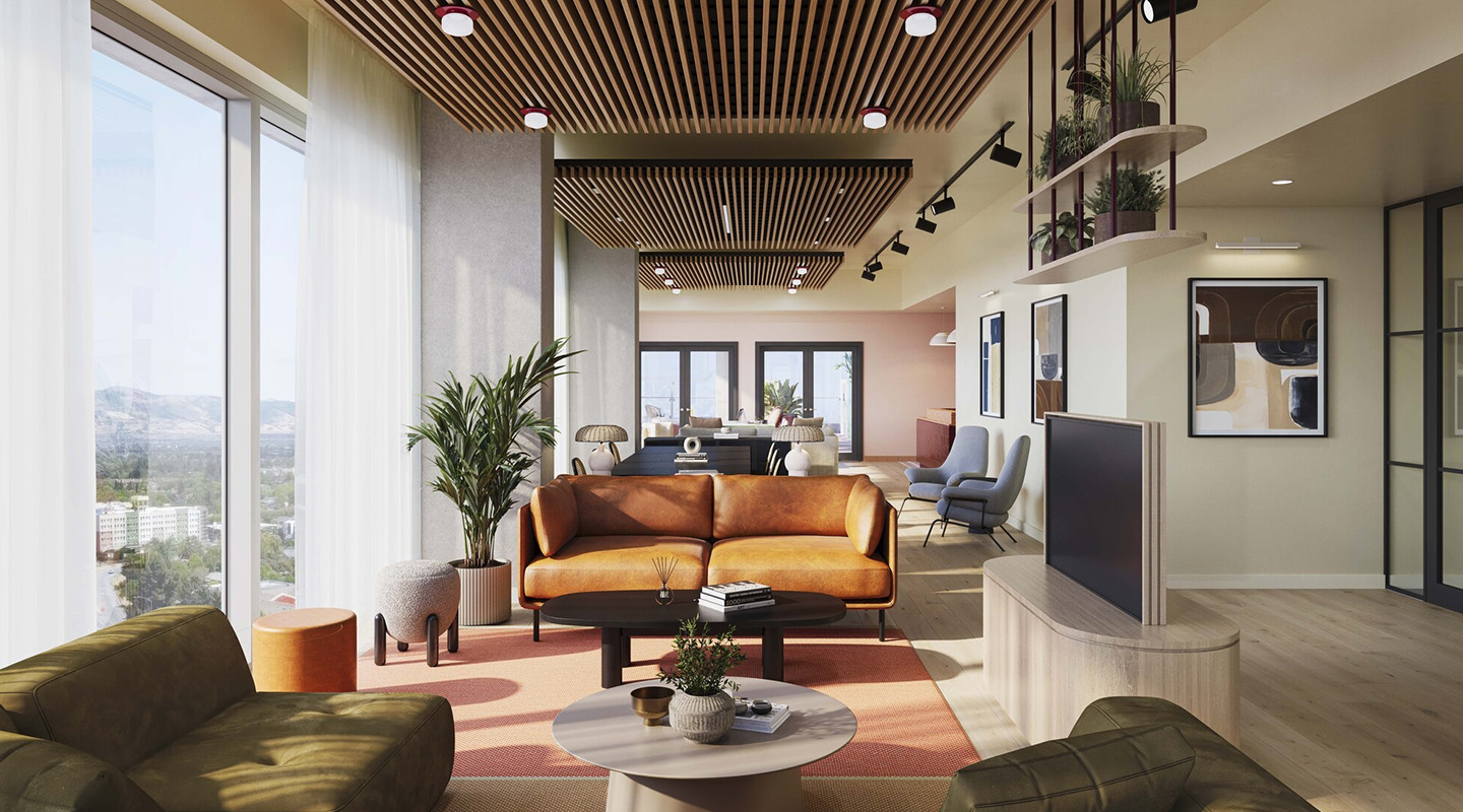 A modern living room with large windows, a brown leather sofa, green armchairs, indoor plants, a round coffee table, and wooden ceiling slats. The space is bright and open, with a dining area in the background.