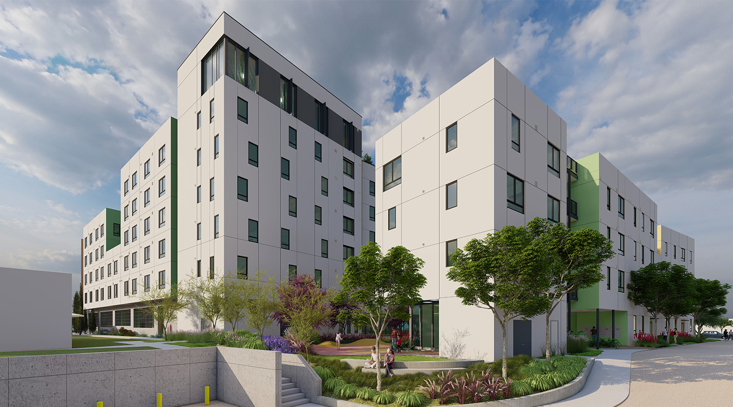 A modern multi-story apartment building with white exterior, large windows, and green accents, surrounded by landscaped greenery, trees, and a pathway under a partly cloudy sky.