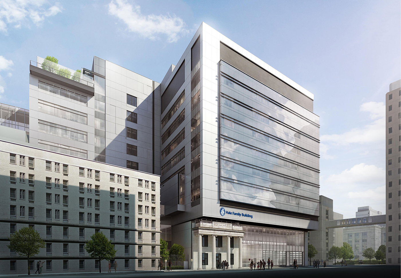 A modern multi-story hospital building with tall glass windows and white panels, surrounded by other buildings under a bright blue sky with some clouds. The entrance sign reads “Fred & Pamela Buffett Cancer Center.”.