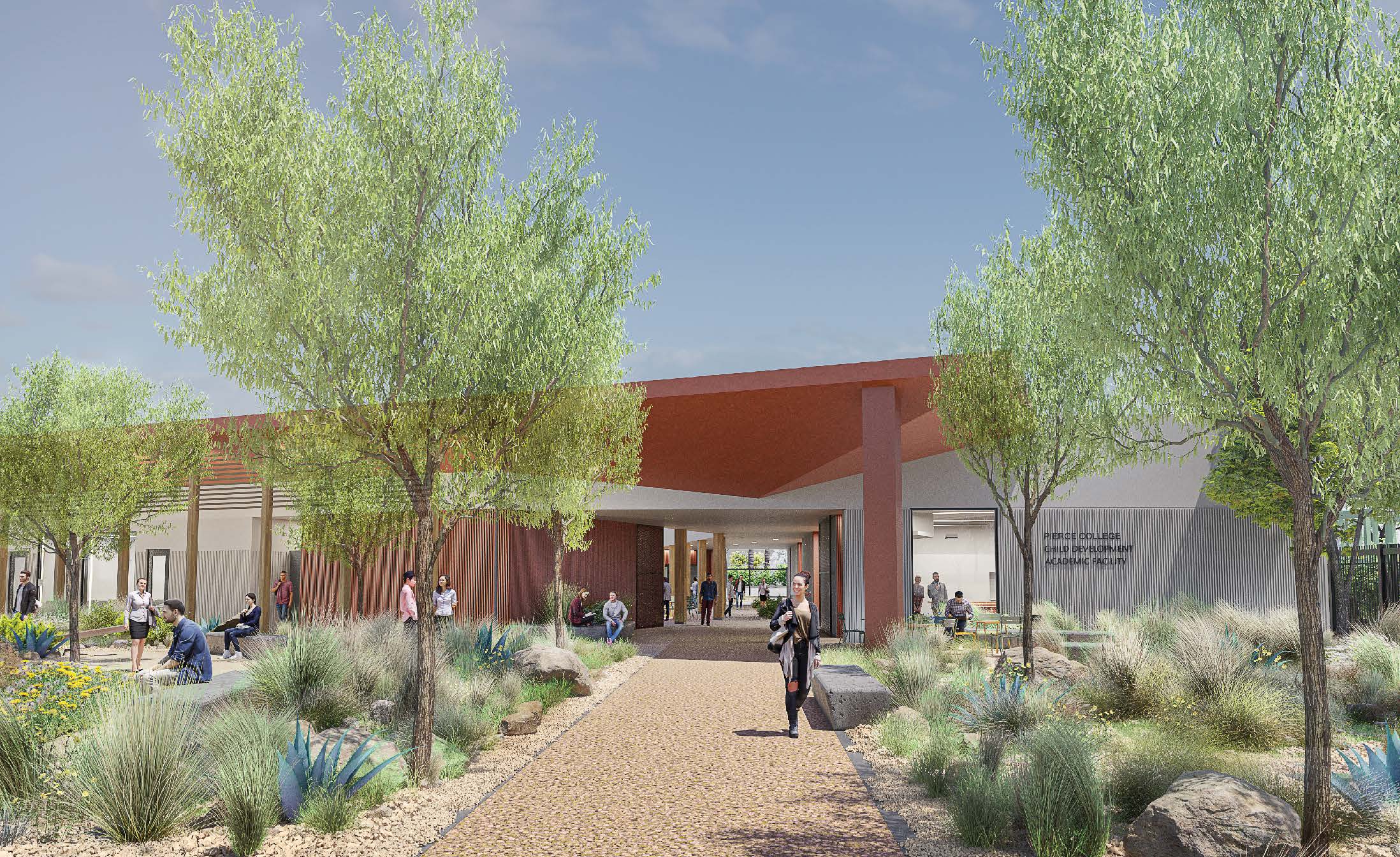 A modern building with a covered entrance is surrounded by landscaped pathways, desert plants, trees, and people walking or sitting outside under a sunny sky.
