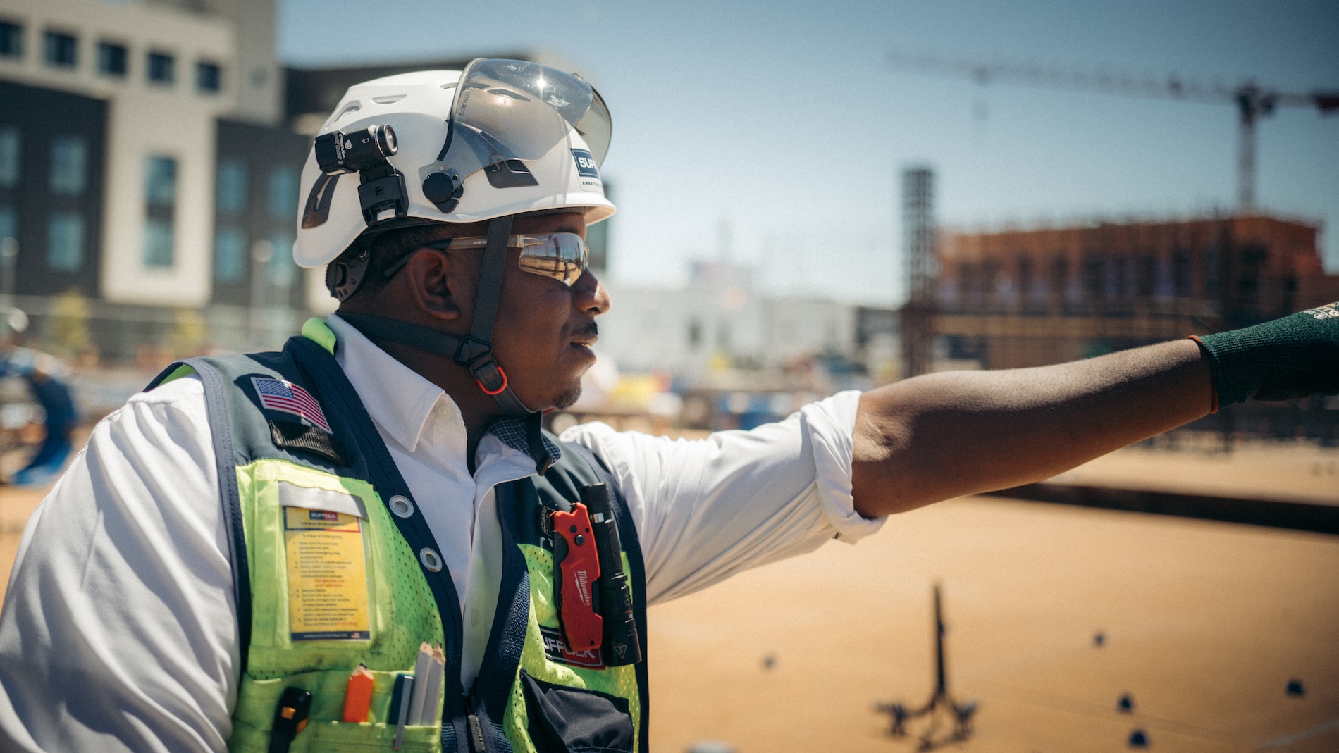 suffolk construction worker in full gear pointing to something out of frame