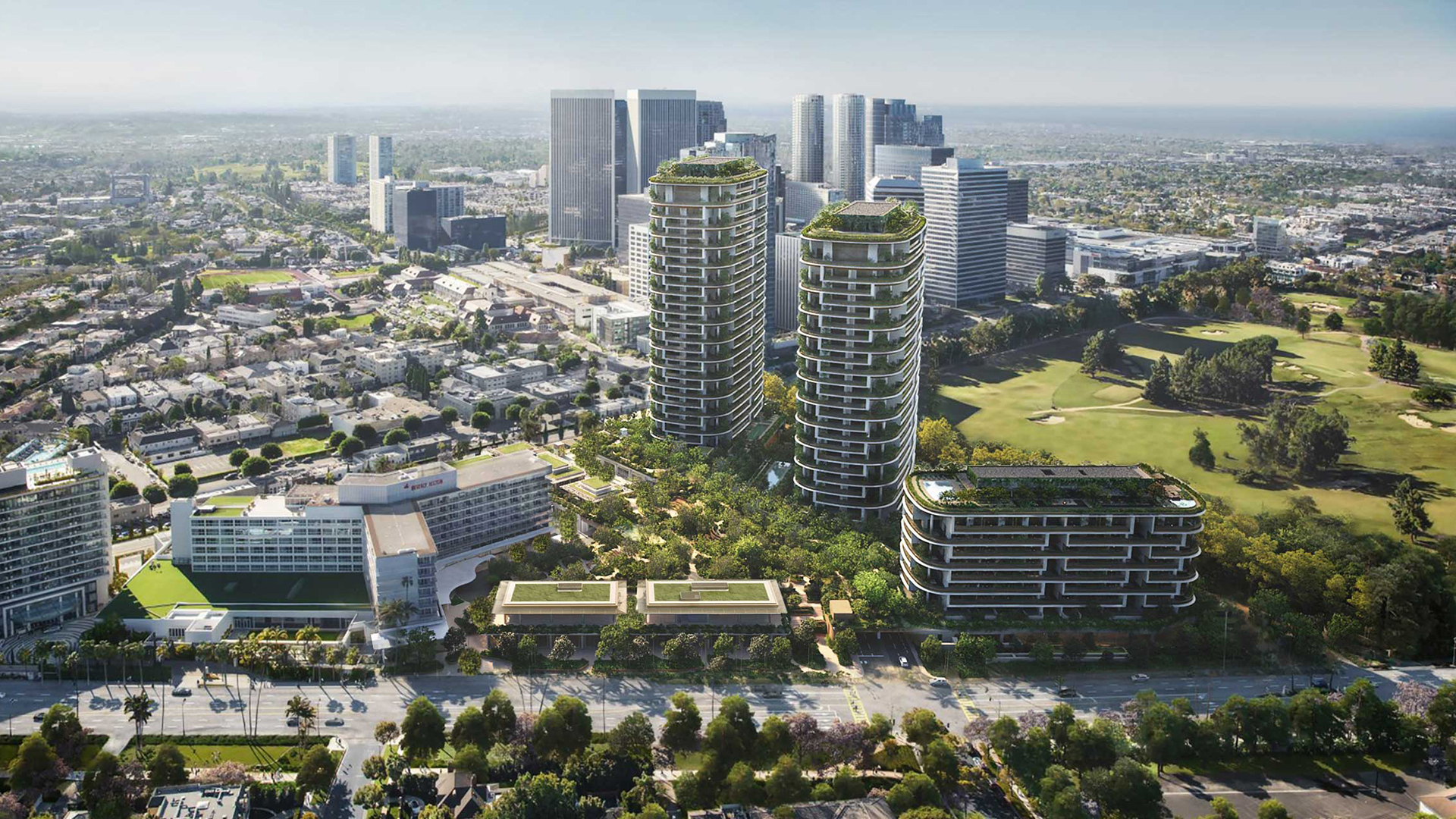 Aerial view of a modern cityscape with two tall, curved glass towers and a shorter building surrounded by greenery, located near a golf course and other high-rise buildings under a clear sky.