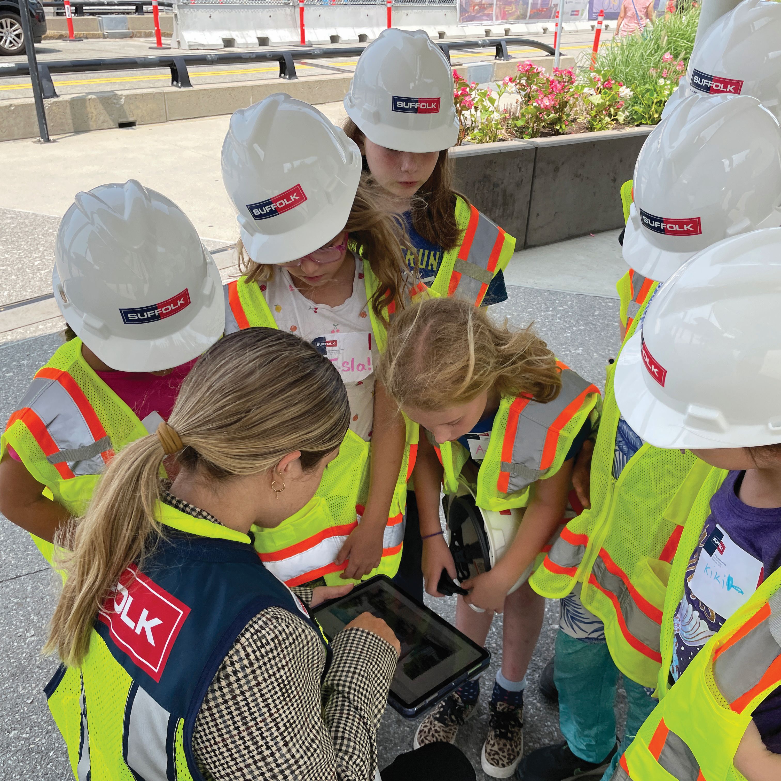 group of kids in suffolk safety gear looking at a tablet