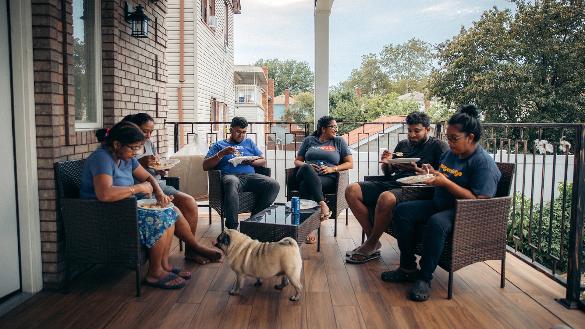 group of suffolk workers sitting on a porch smiling together