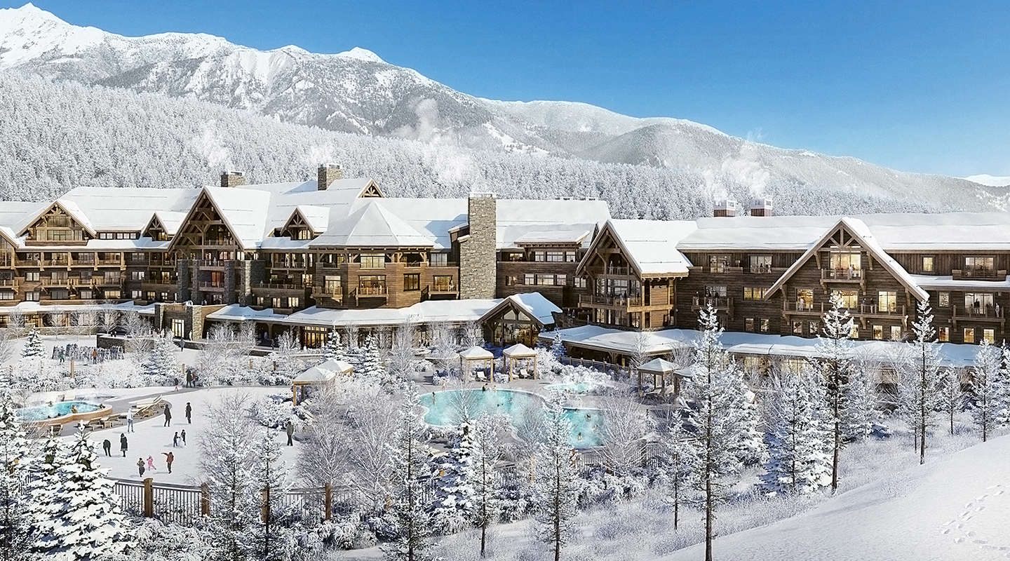 A large wooden lodge surrounded by snow-covered trees and mountains, with outdoor pools and people enjoying winter activities under a clear blue sky.