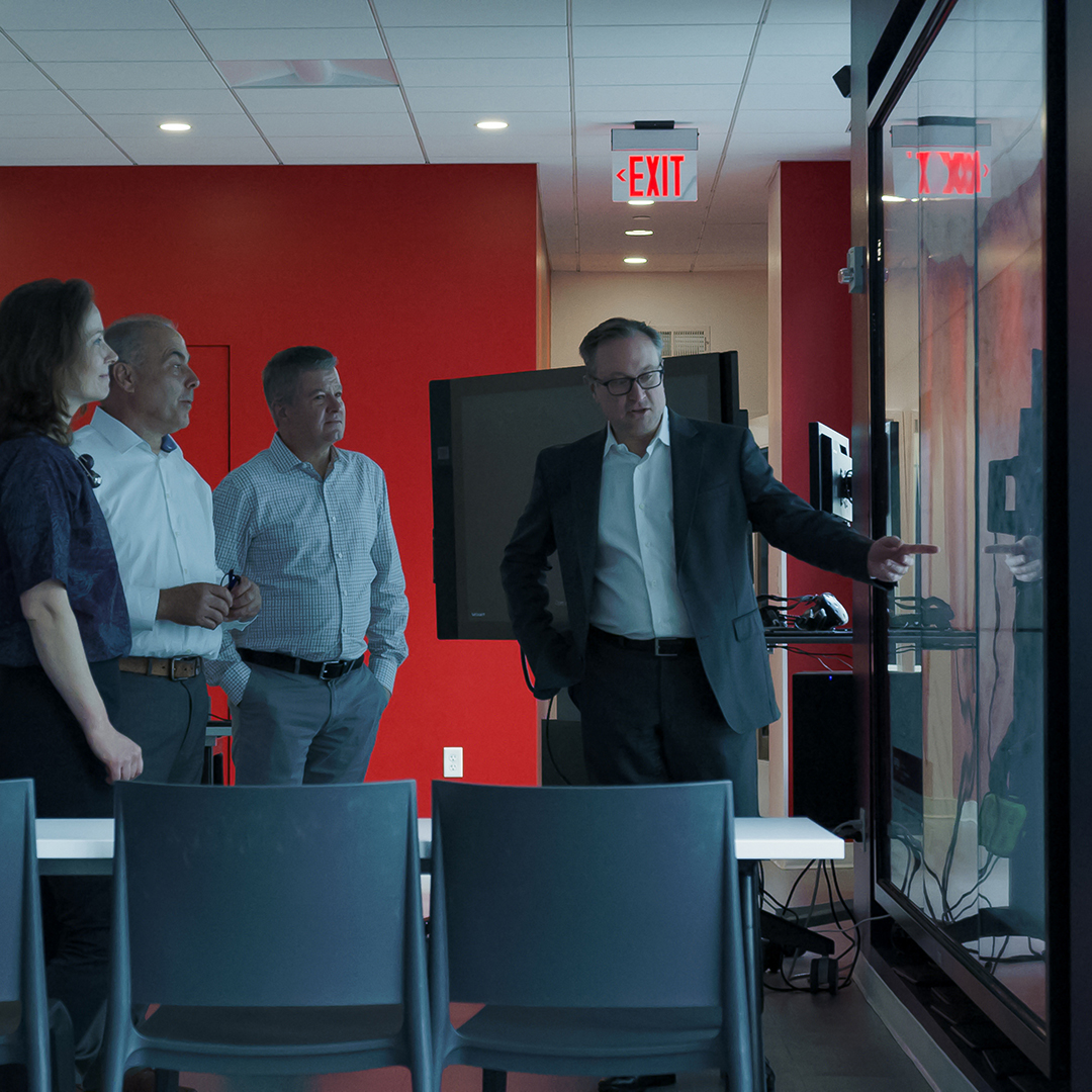 people in board room looking at board