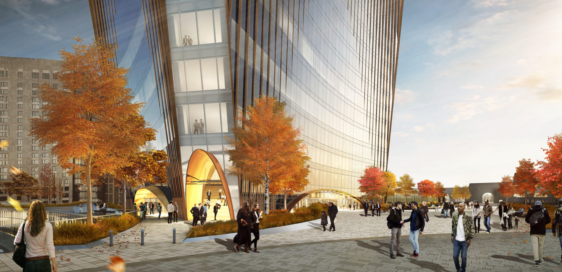 A modern glass skyscraper with a curved facade, surrounded by autumn trees and people walking on a wide plaza under a partly cloudy sky. The building’s entrance features large, arch-shaped structures.